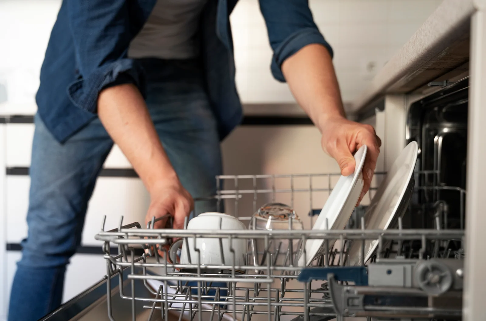 Loading a dishwasher in an Abilene kitchen